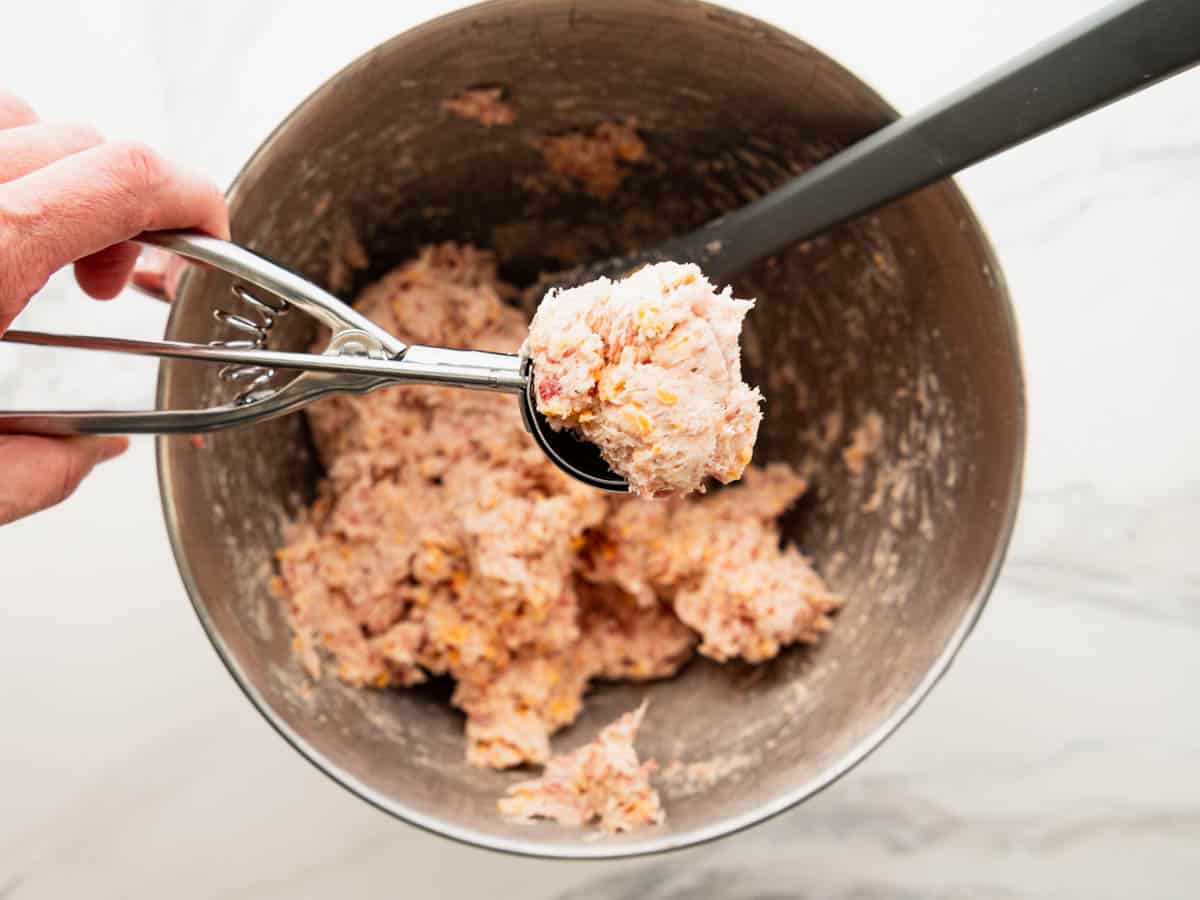 Scooping the sausage ball mixture.