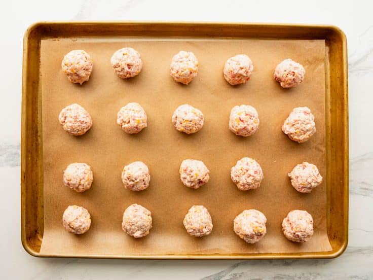 Cream cheese sausage balls on a baking sheet before they go in the oven.