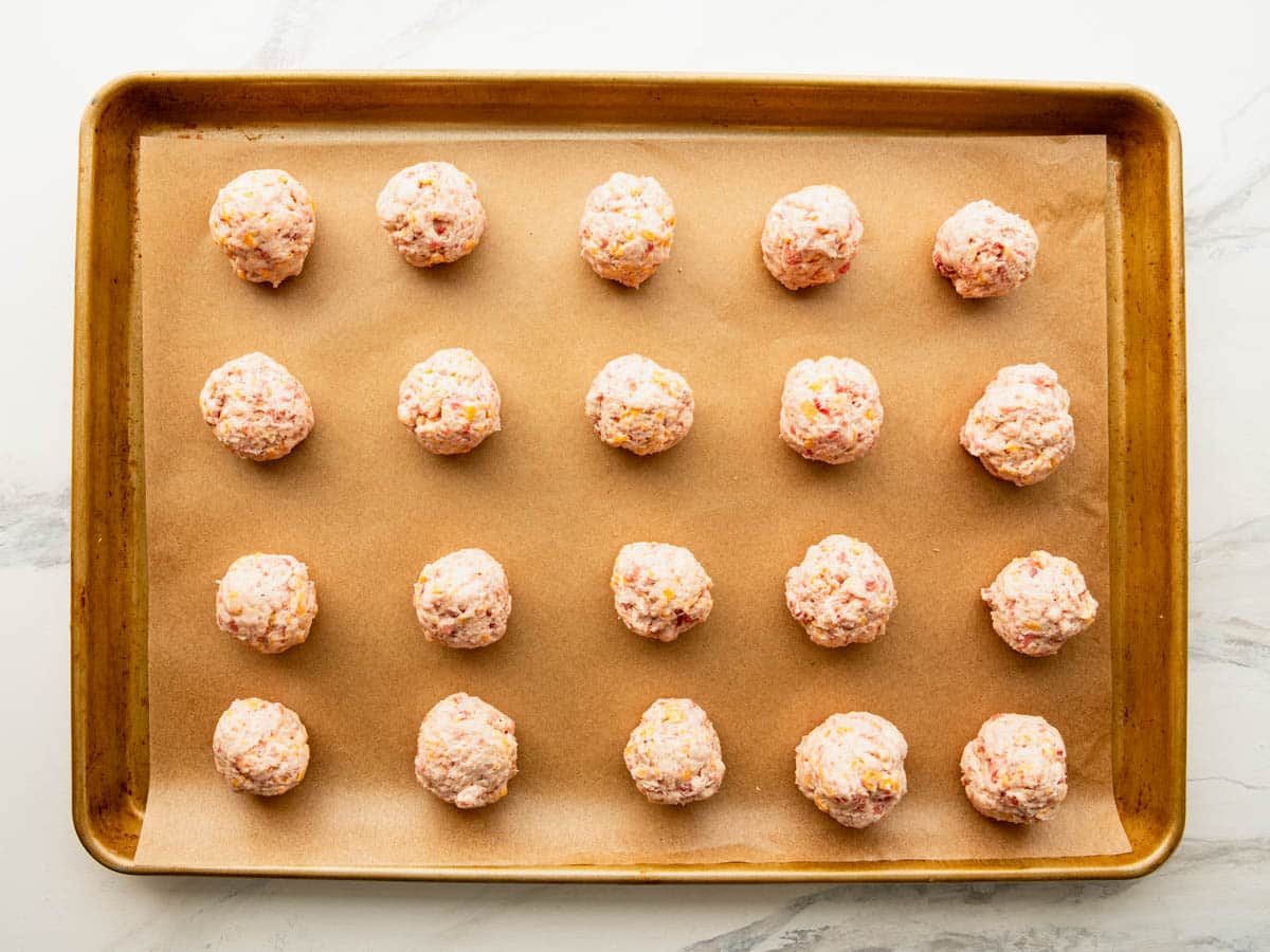 Cream cheese sausage balls on a baking sheet before they go in the oven.