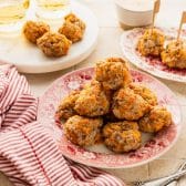 Horizontal side shot of Bisquick cream cheese sausage balls on a table.