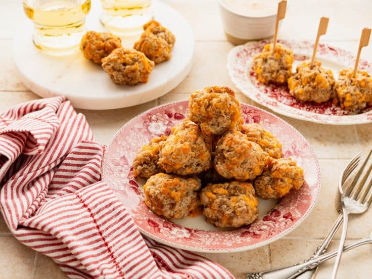 Horizontal side shot of Bisquick cream cheese sausage balls on a table.