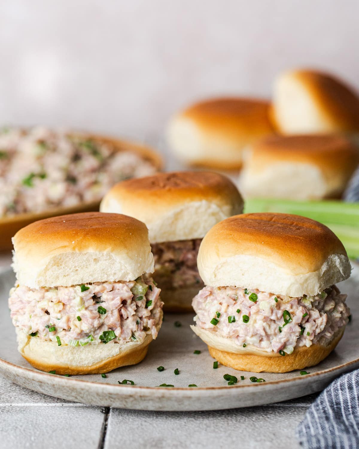 Ham salad sliders on a table.