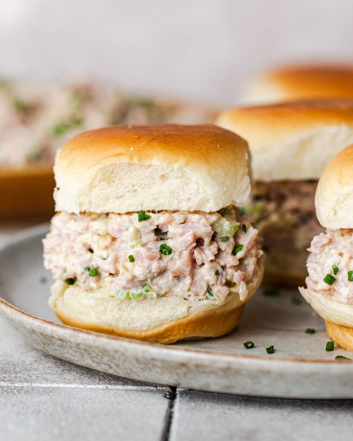 Side shot of ham salad sliders.