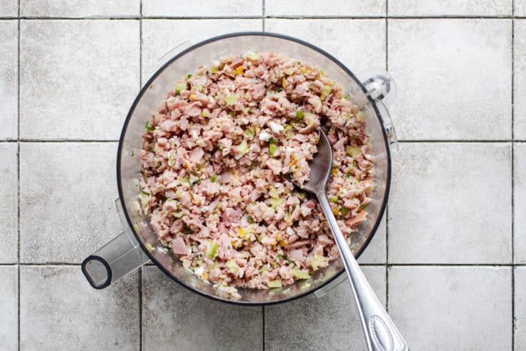 Ham salad ingredients in a food processor.