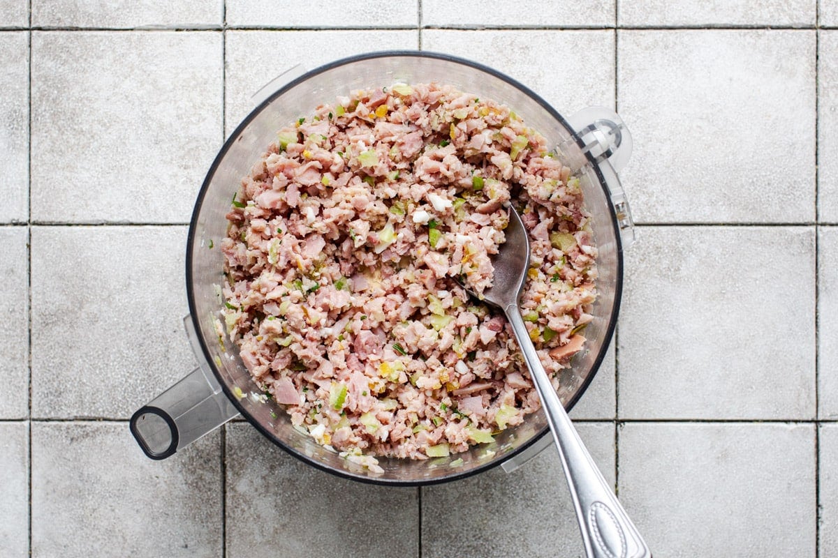 Ham salad ingredients in a food processor.