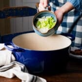 Adding celery and onion to the pot for a hoppin john recipe.