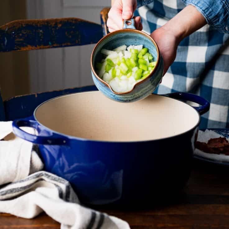 Adding celery and onion to the pot for a hoppin john recipe.