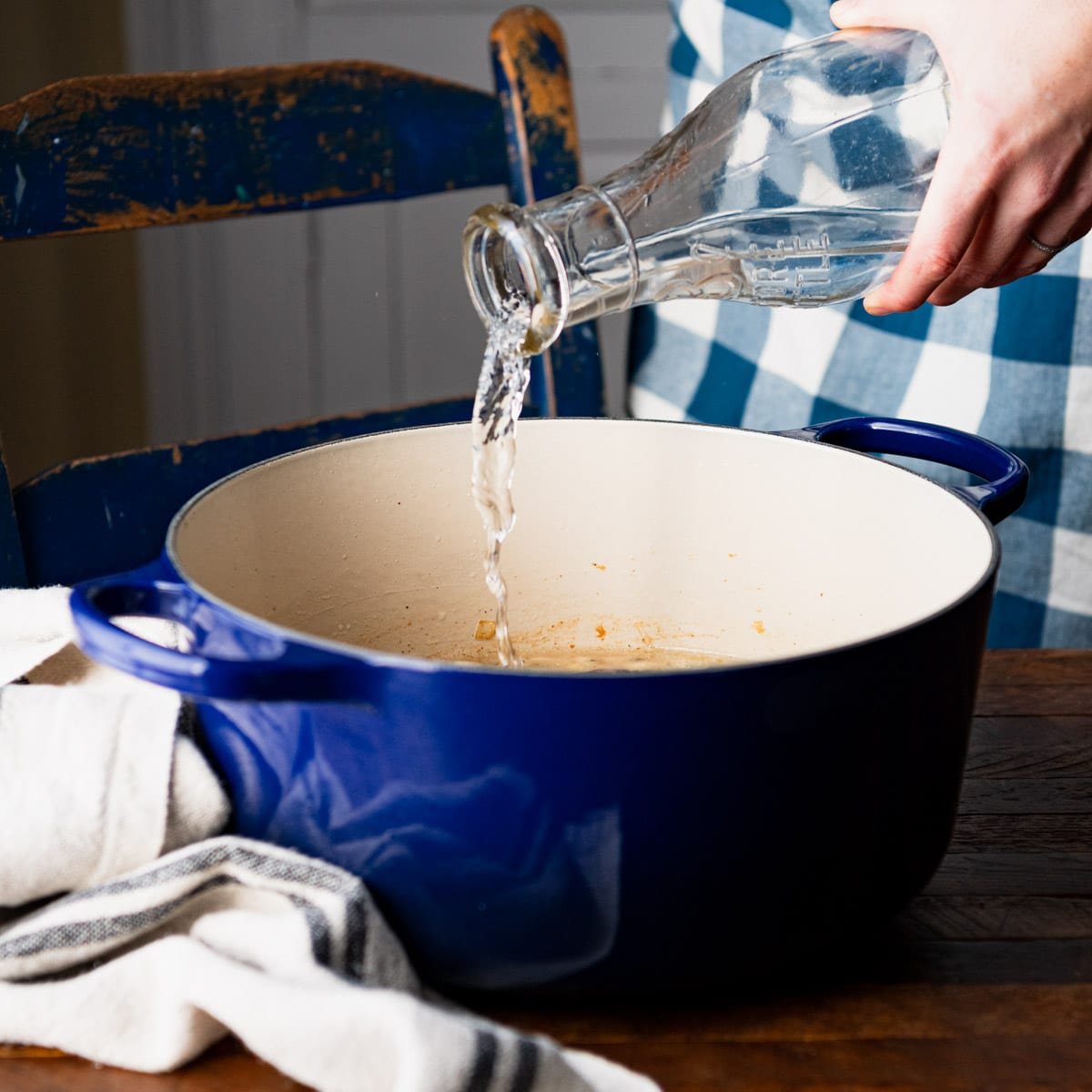 Pouring water into a Dutch oven.