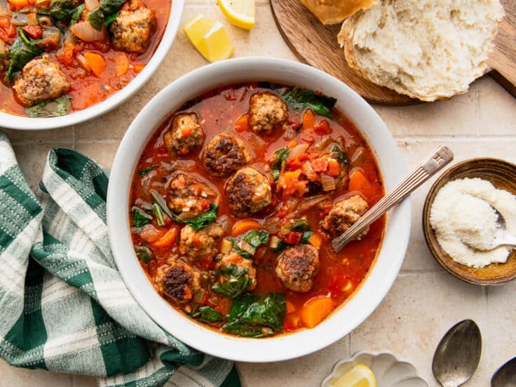 Horizontal overhead shot of two bowls of Italian style meatball soup.
