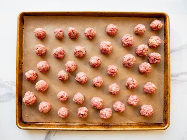 Rolling homemade meatballs.