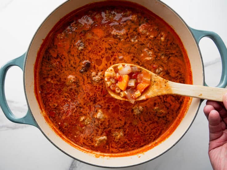 Cooking the pasta in meatball soup.