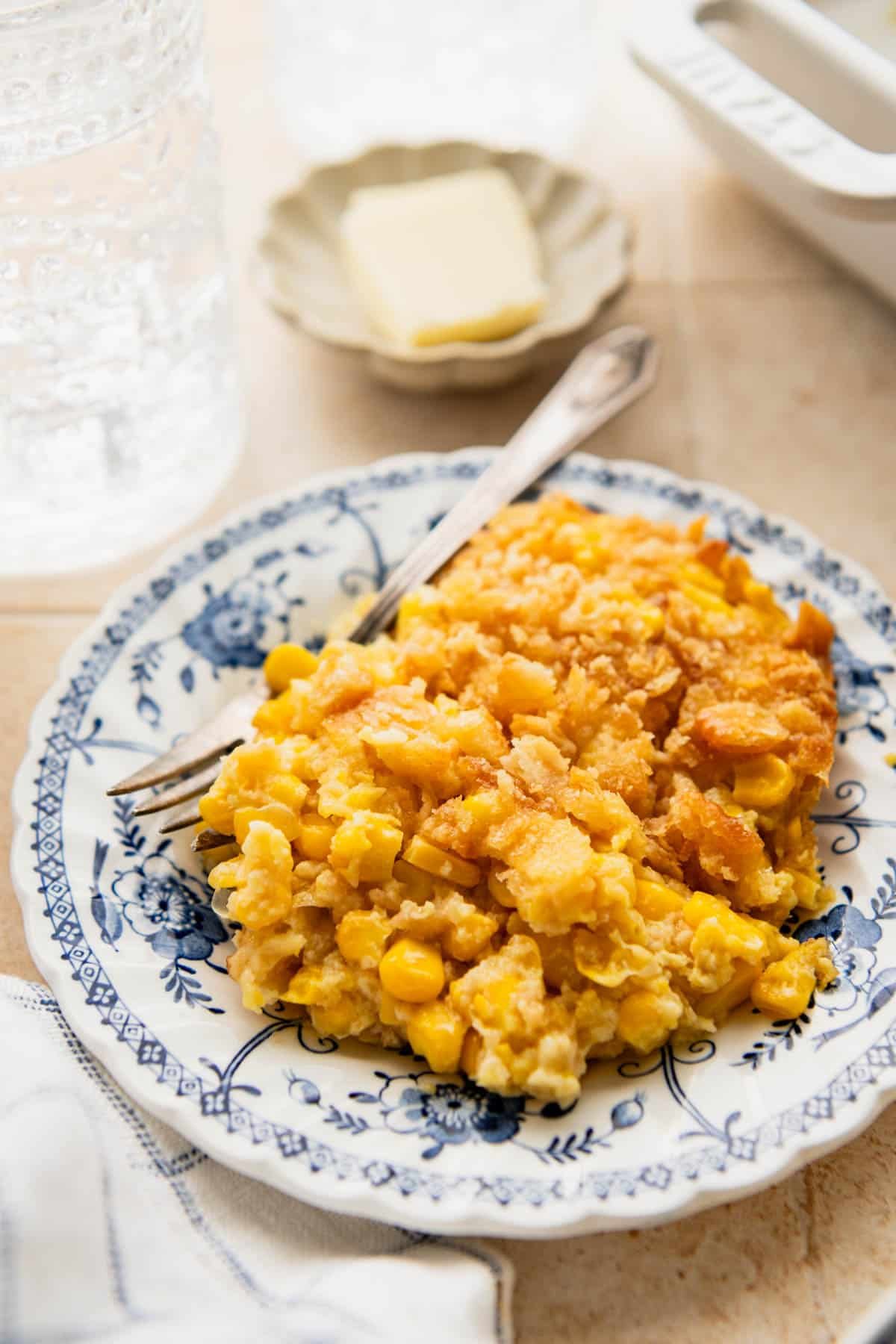 Old fashioned scalloped corn on a blue and white plate.