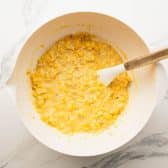 Stirring together ingredients for scalloped corn.