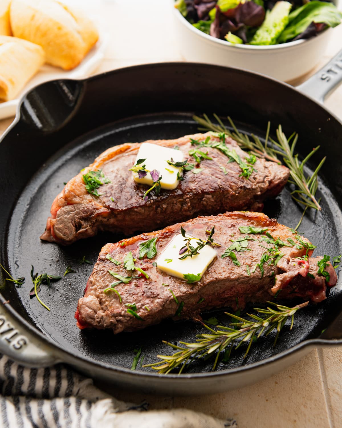 Square side shot of cast iron skillet steak.