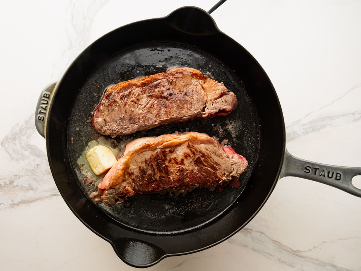 Adding the butter to the skillet.