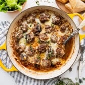 Square overhead shot of a skillet of French onion meatballs.