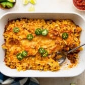 Horizontal overhead shot of a baked tex mex casserole in a white dish.