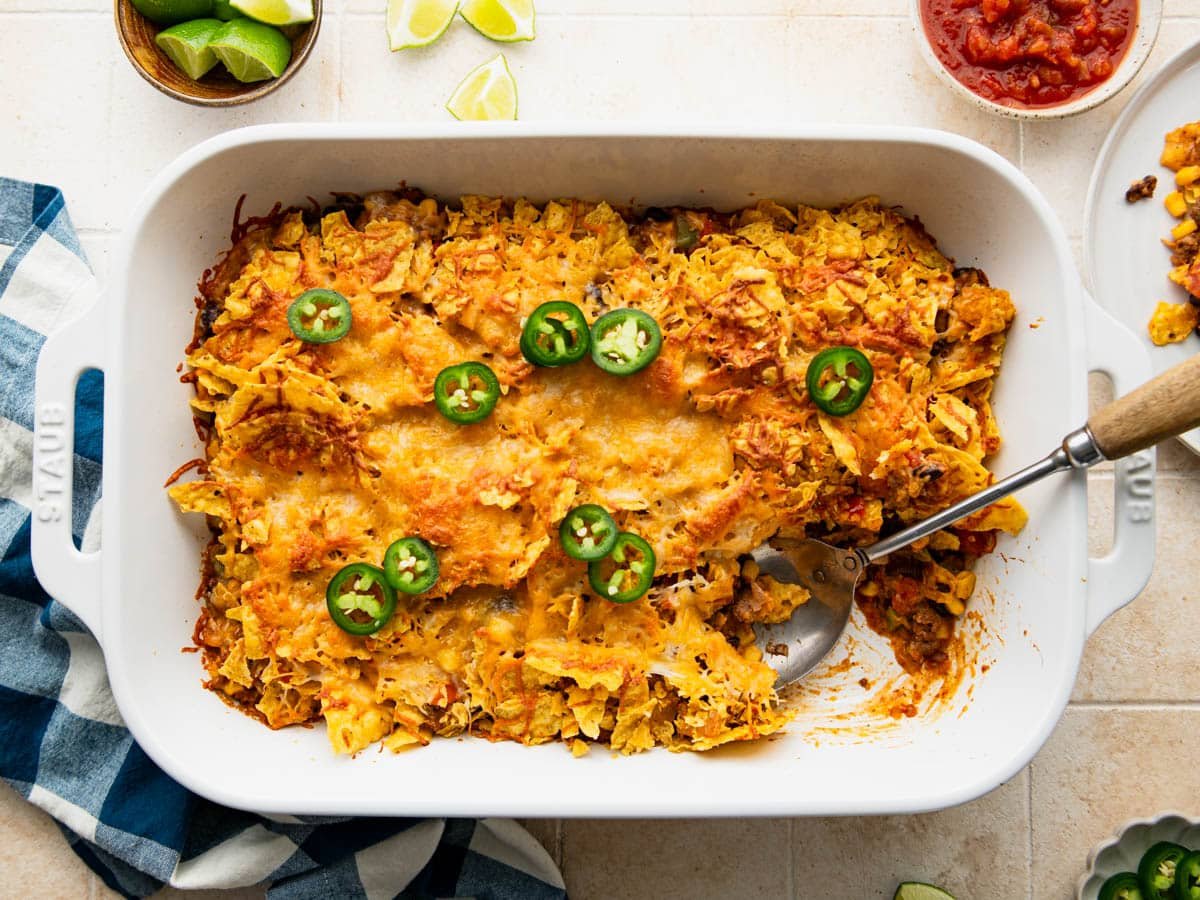 Horizontal overhead shot of a baked tex mex casserole in a white dish.