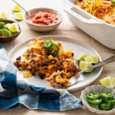 Horizontal side shot of a tex mex casserole on a white plate.