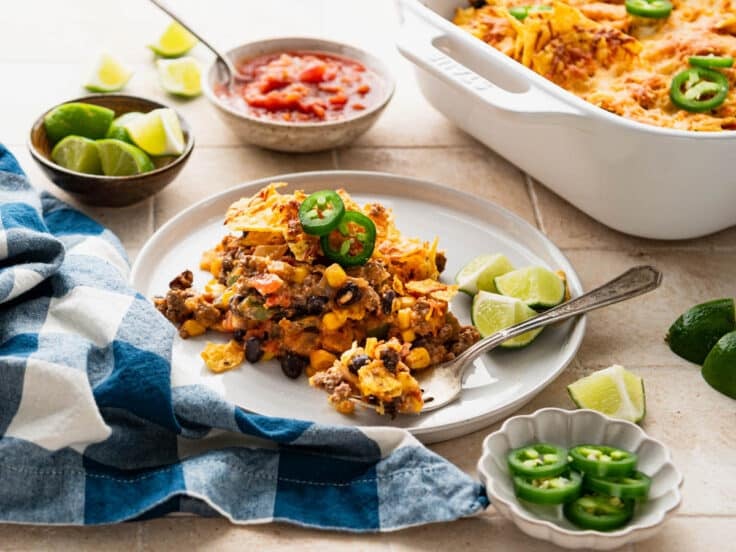 Horizontal side shot of a tex mex casserole on a white plate.