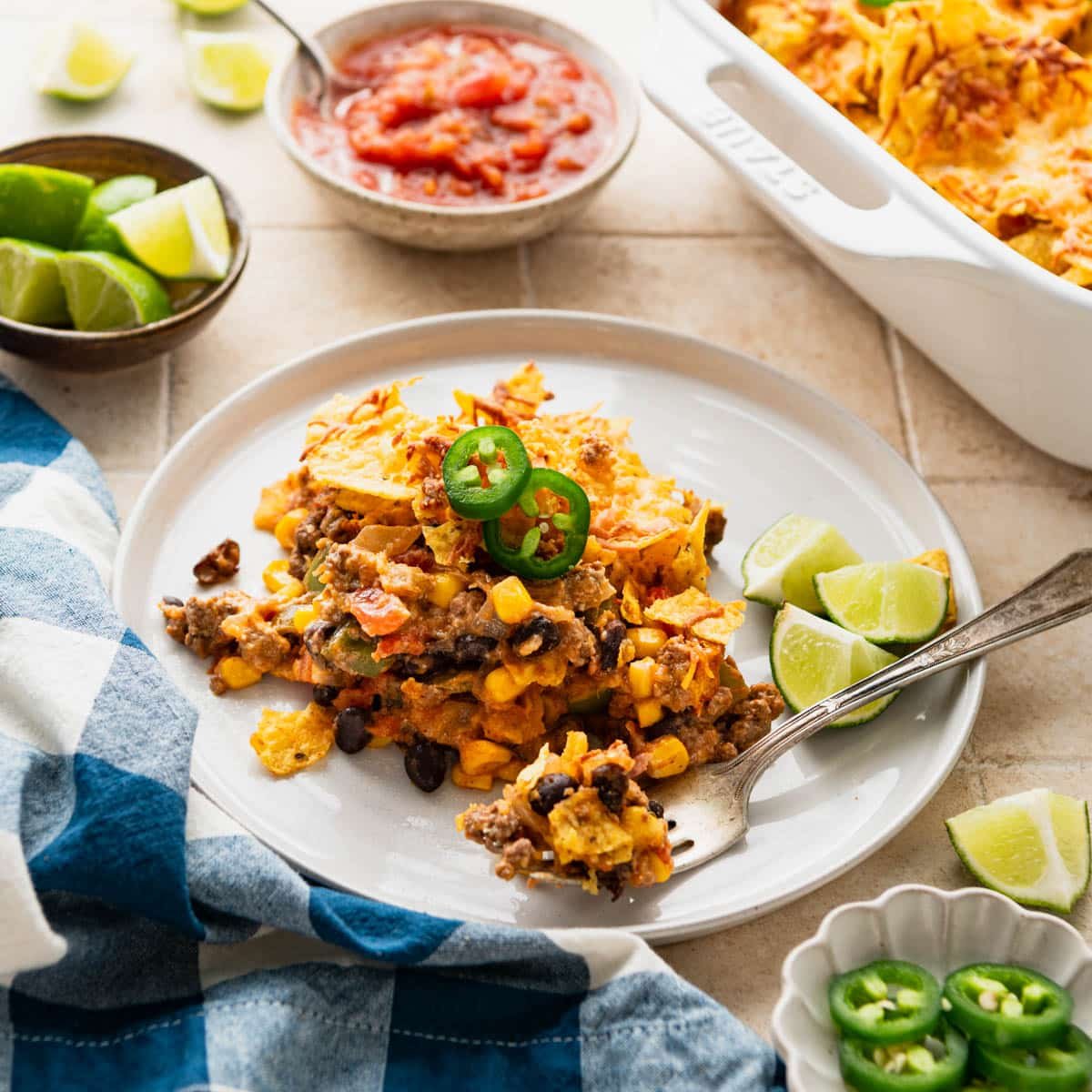 Side shot of tex mex casserole on a white plate.