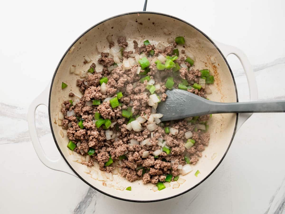 Browning ground beef with onion and green bell pepper.