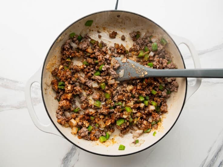 Adding the seasoning to the skillet.