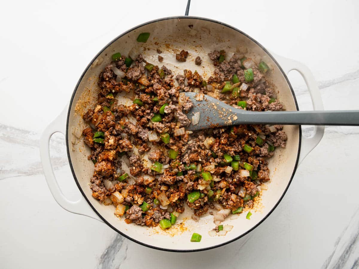 Adding the seasoning to the skillet.