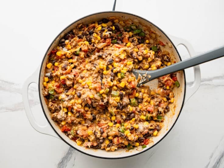 Adding sour cream and cheese to the meat filling.