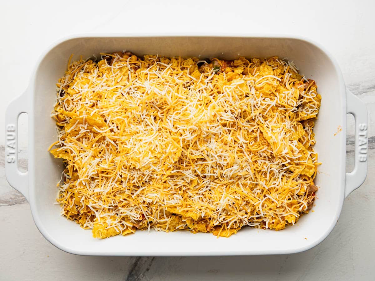 Adding the cheese and the final layer of chips.