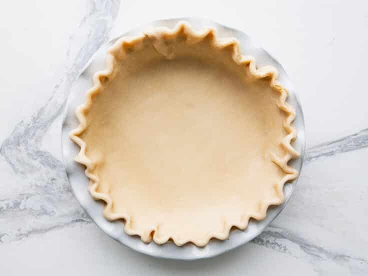Pie crust in a pie plate before baking.