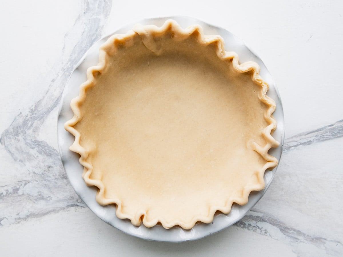 Pie crust in a pie plate before baking.