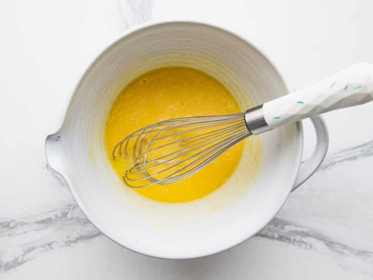 Whisking the eggs.
