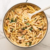 Adding the pasta and chicken back to the skillet.