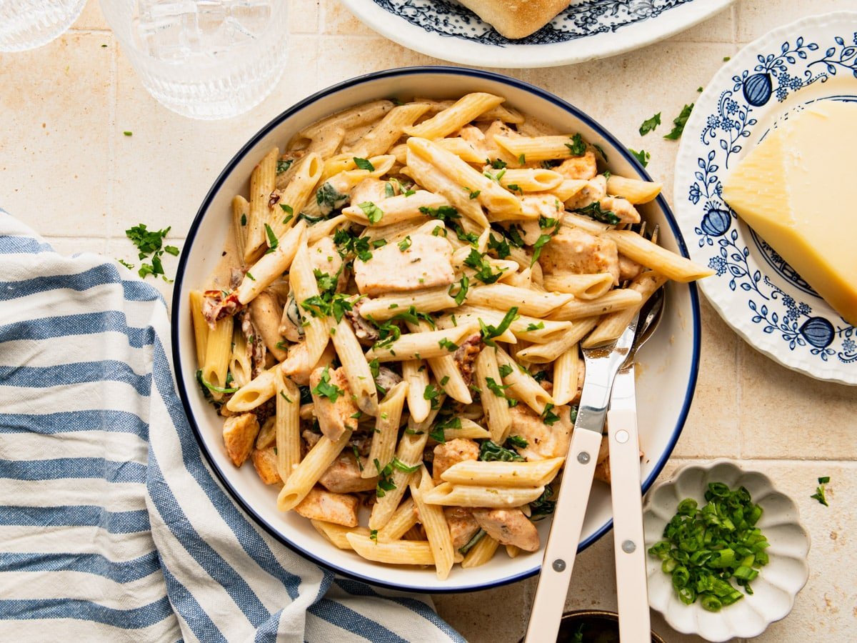 Horizontal overhead image of a bowl of Tuscan chicken pasta.