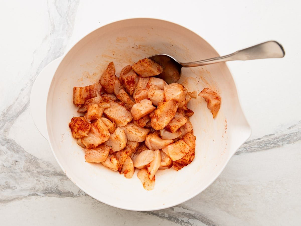 Diced chicken breast seasoned with paprika, salt, and pepper.