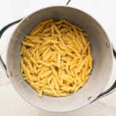 Cooked and drained penne pasta.
