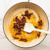 Adding the sun dried tomatoes to the pan.