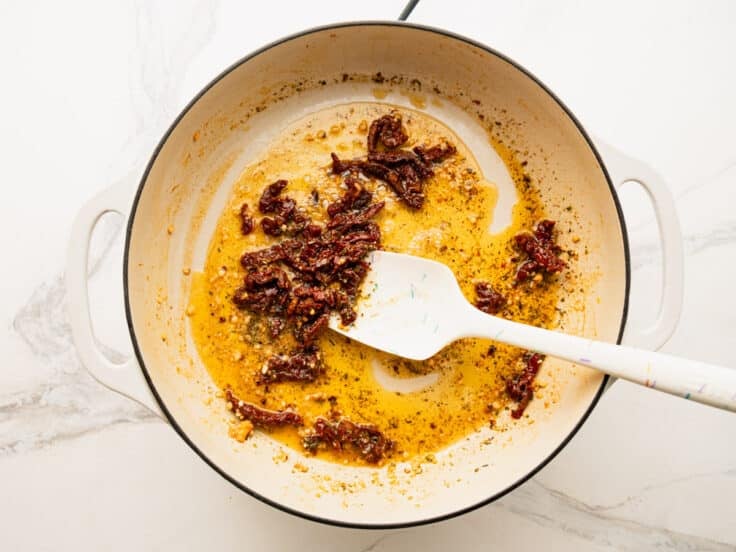 Adding the sun dried tomatoes to the pan.