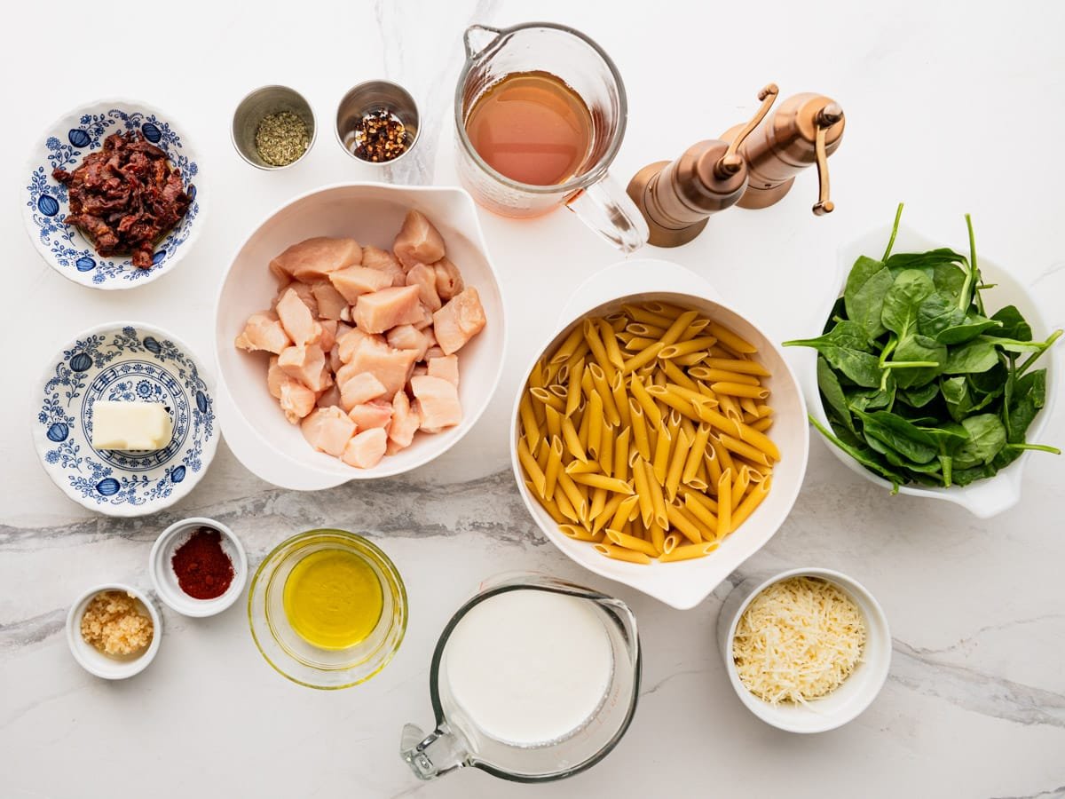 Ingredients for a creamy Tuscan chicken pasta recipe.