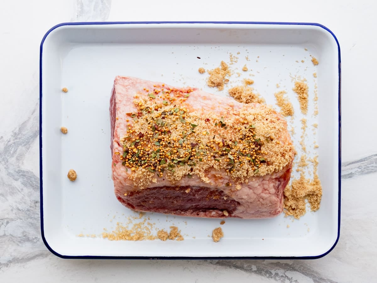 Seasoning a corned beef.
