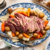 Horizontal overhead image of a platter of sliced crock pot corned beef and cabbage.