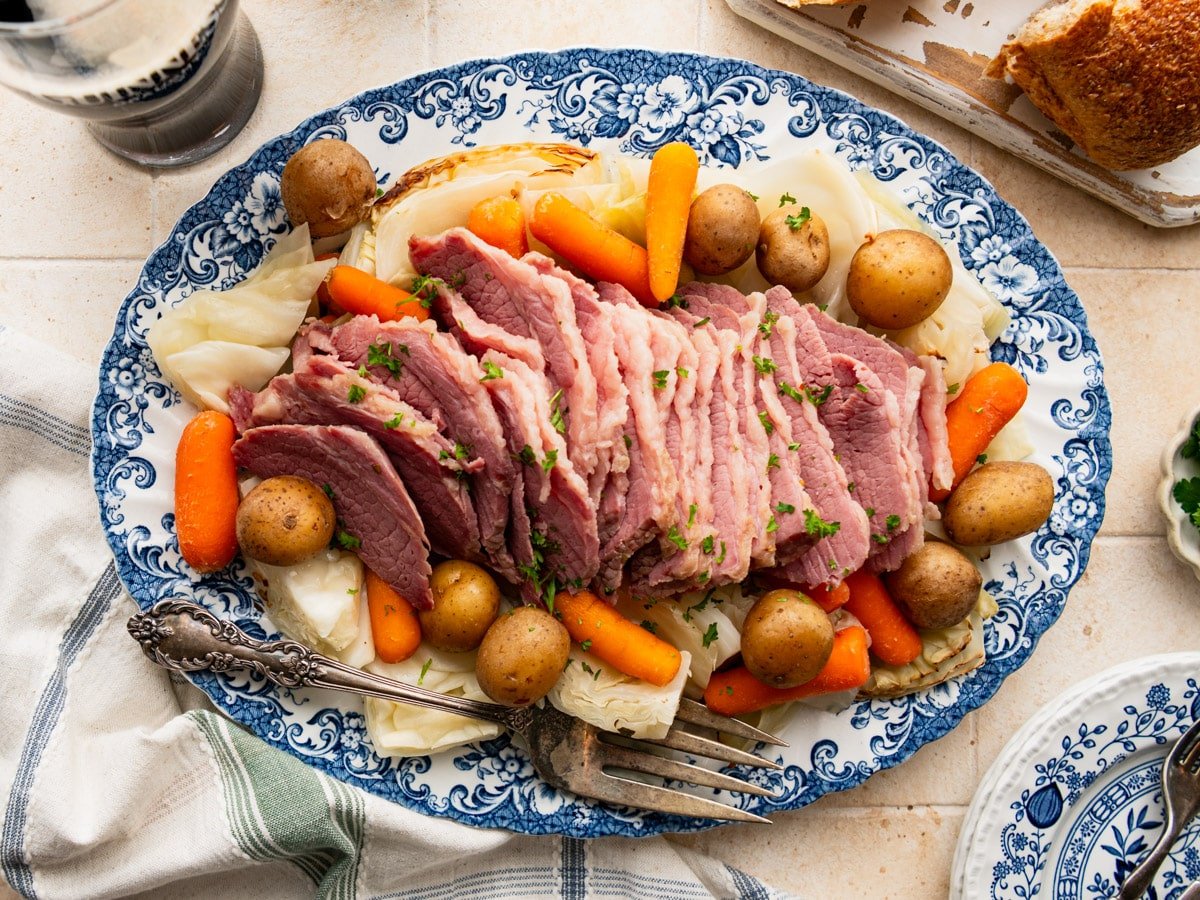 Horizontal overhead image of a platter of sliced crock pot corned beef and cabbage.