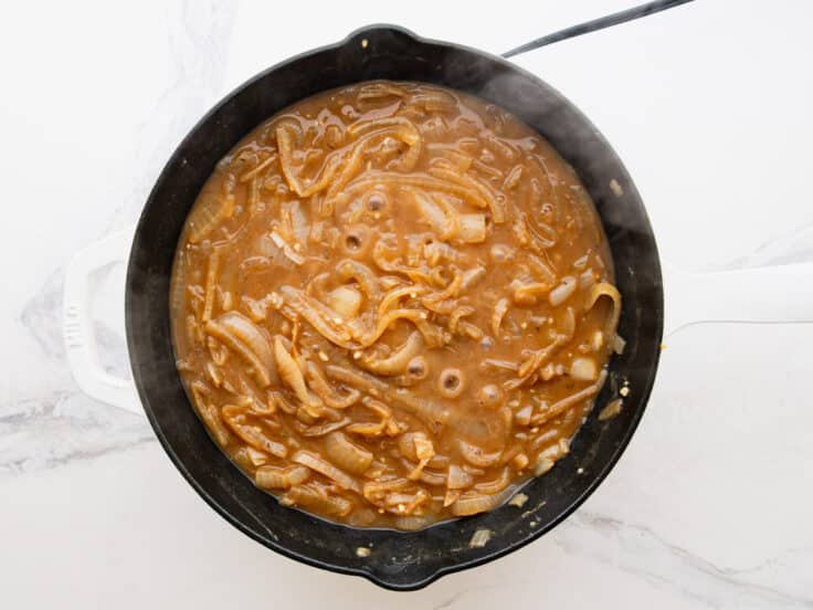 Simmering the sauce for French onion pork chops.