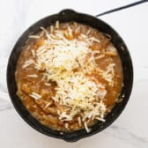 Adding the grated Gruyere to the top.