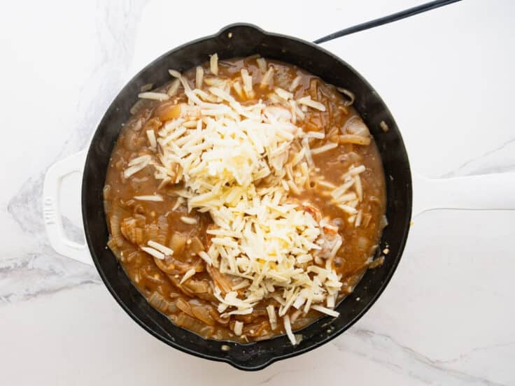 Adding the grated Gruyere to the top.