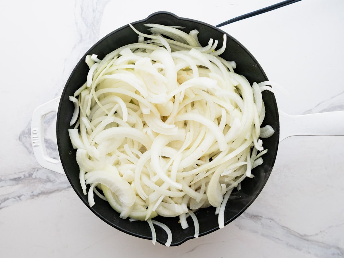 Adding the onions to the skillet.