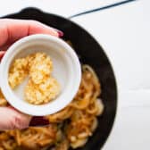 MInced garlic going into the skillet.