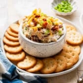 Horizontal side shot of million dollar dip served with Ritz crackers.