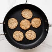 Browning sausage patties in a skillet.